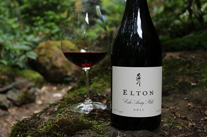 Shot of Elton Pinot Noir with full glass of wine in the garden