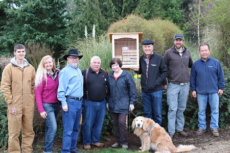 Team who installed the bee boxes standing next to completed box