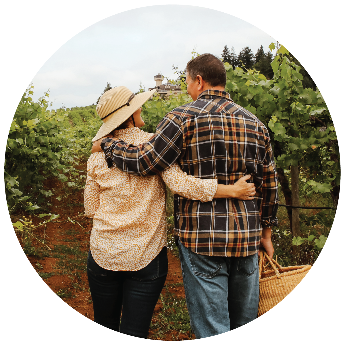 An image of Winery Owners walking through the Estate Vineyard