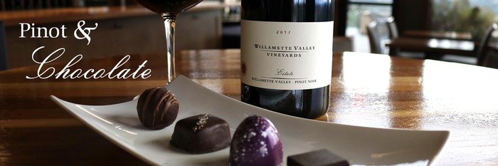 Pinot noir with assorted small chocolates on plate.