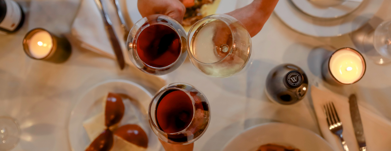place setting with forks and knifes, menu and wine glasses