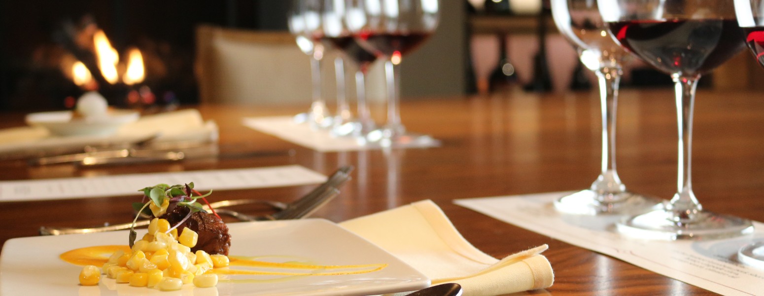 place setting with forks and knifes, menu and wine glasses