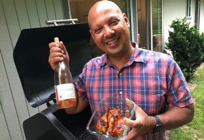 Winemaker Joe holding rosé and smoked meat
