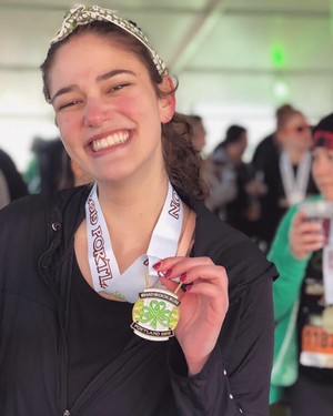 Kara holding a metal from the Shamrock Run in Porltand