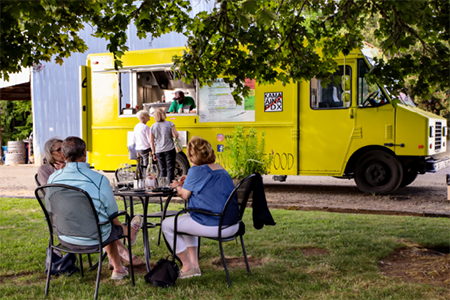 Image of guests enjoying food and wine during Tualatin Estate Vineyards Friday night Food Truck and Wine Event.
