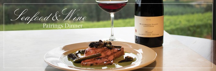 Salmon in sauce with a glass of pinot noir.