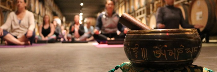 Winery Guests doing yoga in the cellar.