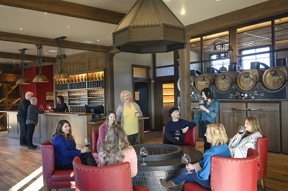 group gathered around the fireplace with wine at Willamette Wineworks