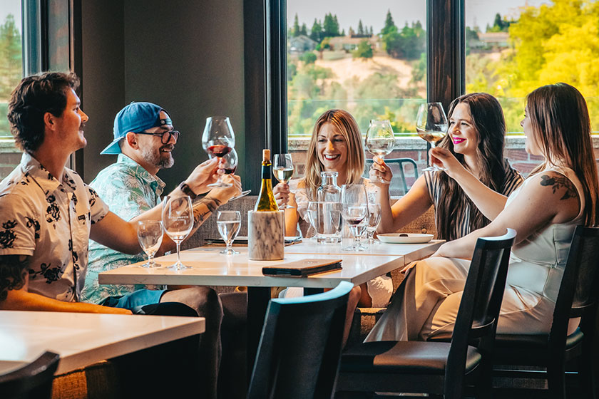 group gathered around the fireplace with wine at Willamette Wineworks