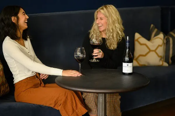 People enjoying wine at Maison Bleue